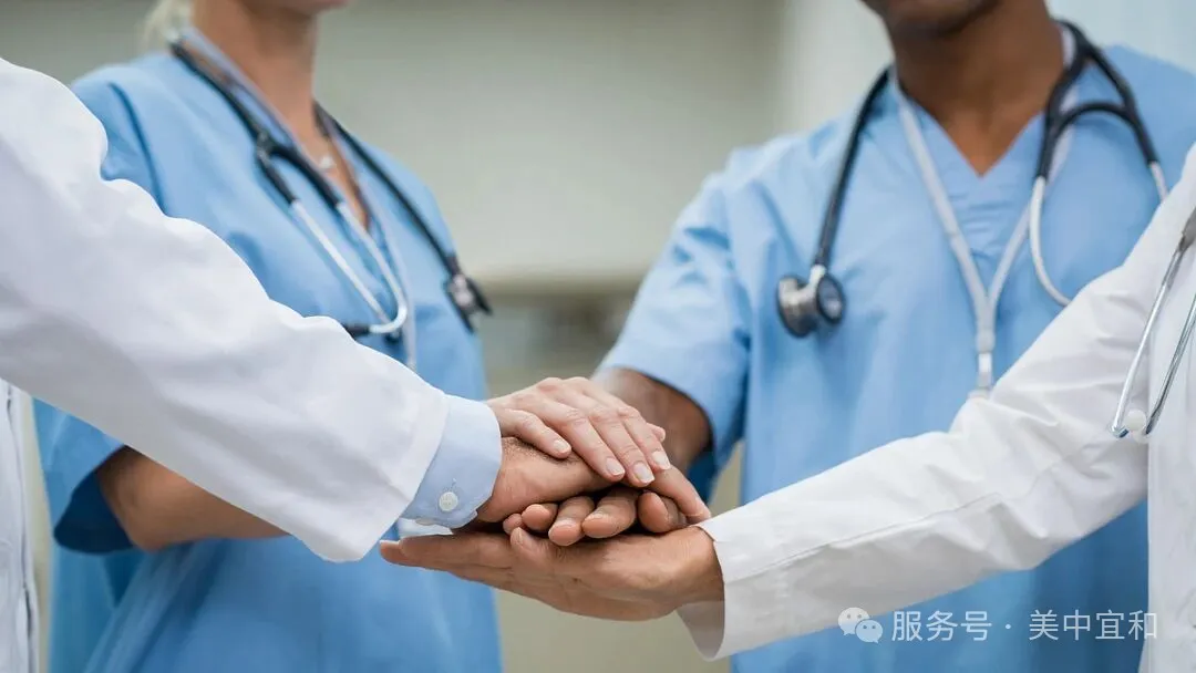 Medical team joining hands in collaboration